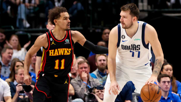Hawks guard Trae Young defends Mavericks guard Luka Doncic.